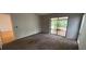 Neutral carpeted living room with sliding glass doors to outdoor space at 5032 81St Avenue E Ter, Sarasota, FL 34243