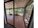 View from living area to tiled screened porch and fenced yard at 5032 81St Avenue E Ter, Sarasota, FL 34243