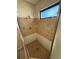 Walk-in shower with tile surround, window, and shower head at 5032 81St Avenue E Ter, Sarasota, FL 34243