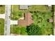 Aerial view of a home with a well-manicured lawn and mature trees in a residential neighborhood at 5213 20Th Street E Ct, Bradenton, FL 34203
