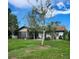 Backyard featuring a screened porch for outdoor enjoyment, surrounded by mature trees at 5213 20Th Street E Ct, Bradenton, FL 34203