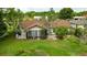 Exterior view of a house with a well-maintained lawn and a cozy screened-in lanai at 5213 20Th Street E Ct, Bradenton, FL 34203
