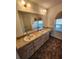 Bathroom featuring double sinks with ample counter space and storage cabinets at 5213 20Th Street E Ct, Bradenton, FL 34203