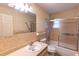 Bathroom with white sink, toilet, tile surround tub and shower at 5213 20Th Street E Ct, Bradenton, FL 34203
