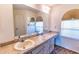 Bathroom featuring double sinks, cabinets and a large mirror at 5213 20Th Street E Ct, Bradenton, FL 34203