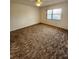 Carpeted bedroom with a large window and ample natural light at 5213 20Th Street E Ct, Bradenton, FL 34203