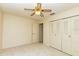 Bedroom with carpet, a ceiling fan and large closet doors at 5213 20Th Street E Ct, Bradenton, FL 34203
