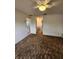 Spacious carpeted bedroom featuring a ceiling fan and access to the bathroom at 5213 20Th Street E Ct, Bradenton, FL 34203
