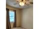 Bedroom with a ceiling fan and light, plus curtains on the window at 5213 20Th Street E Ct, Bradenton, FL 34203