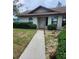 Neat front exterior featuring a sidewalk, well-manicured bushes, and clean lawn at 5213 20Th Street E Ct, Bradenton, FL 34203