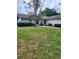 Inviting front yard with lush green grass and manicured bushes enhances curb appeal at 5213 20Th Street E Ct, Bradenton, FL 34203