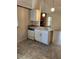 Functional kitchen space with an island, dishwasher, and view of the fireplace at 5213 20Th Street E Ct, Bradenton, FL 34203