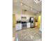 Modern kitchen with stainless steel appliances and white cabinets, illuminated by overhead lighting at 5213 20Th Street E Ct, Bradenton, FL 34203
