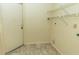 Small laundry room with tile flooring and overhead shelving at 5213 20Th Street E Ct, Bradenton, FL 34203