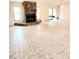 Open-concept living room featuring a stone fireplace and neutral-colored tile flooring at 5213 20Th Street E Ct, Bradenton, FL 34203