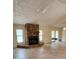 Spacious living room featuring a stone fireplace, tile flooring, and sliding glass doors at 5213 20Th Street E Ct, Bradenton, FL 34203