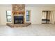 Cozy living room featuring a stone fireplace, tile flooring, and natural light at 5213 20Th Street E Ct, Bradenton, FL 34203