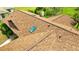 Aerial view of a house roof with brown shingles and a blue skylight window at 5213 20Th Street E Ct, Bradenton, FL 34203