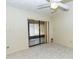 An interior room with tile floors, an exit to the exterior and a ceiling fan at 5213 20Th Street E Ct, Bradenton, FL 34203