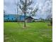 Exterior image of shed set in large open lot with tree in foreground at 5213 20Th Street E Ct, Bradenton, FL 34203