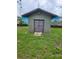 A small shed on a grassy lot surrounded by a partial fence, offering outdoor storage at 5213 20Th Street E Ct, Bradenton, FL 34203