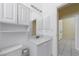 Bathroom with white vanity, granite countertop, and a view into the hallway at 5410 Matthew Ct, Sarasota, FL 34231