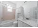 Bathroom featuring pink tile, white cabinets, and a large mirror at 5410 Matthew Ct, Sarasota, FL 34231