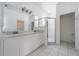 Bright bathroom featuring double sinks, a walk-in shower, and tile flooring at 5410 Matthew Ct, Sarasota, FL 34231