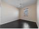 Bedroom with dark wood floors, neutral walls, and a bright window with blinds at 5410 Matthew Ct, Sarasota, FL 34231
