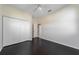 Bedroom featuring dark wood floors, neutral walls, and a closet at 5410 Matthew Ct, Sarasota, FL 34231