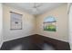 Bedroom with hardwood floors, two windows, and natural light at 5410 Matthew Ct, Sarasota, FL 34231