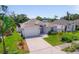 Well-maintained home featuring a two-car garage, manicured lawn, and a tidy landscaped yard at 5410 Matthew Ct, Sarasota, FL 34231