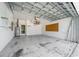Spacious empty garage with water heater, storage rack and peg board at 5410 Matthew Ct, Sarasota, FL 34231