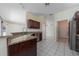 Granite countertops, stainless steel dishwasher and dark wood cabinets in kitchen at 5410 Matthew Ct, Sarasota, FL 34231
