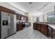 Spacious kitchen features stainless steel appliances, granite countertops, and white tile flooring at 5410 Matthew Ct, Sarasota, FL 34231