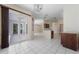 Large living space with sliding glass doors, tile floors and adjacent kitchen at 5410 Matthew Ct, Sarasota, FL 34231