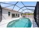 Backyard pool area featuring white tile deck and covered screen enclosure at 5410 Matthew Ct, Sarasota, FL 34231