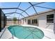 Pool area featuring white tile deck and screen enclosure with backyard views at 5410 Matthew Ct, Sarasota, FL 34231