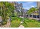 Paver steps through a lush landscaped backyard offer access to a screened pool, hot tub, and outdoor living area at 5515 69Th E Pl, Ellenton, FL 34222