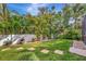 Professionally landscaped backyard with lush green lawn, garden beds, and privacy creates a tranquil outdoor space at 5515 69Th E Pl, Ellenton, FL 34222