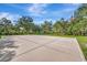 Outdoor community basketball court, surrounded by mature trees, perfect for recreational games and exercise at 5515 69Th E Pl, Ellenton, FL 34222