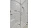 Modern walk-in shower featuring marble-style tile, corner seat, and dual shower heads at 5515 69Th E Pl, Ellenton, FL 34222