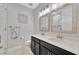 Well-lit bathroom featuring double vanity with white countertops and decorative wall art at 5515 69Th E Pl, Ellenton, FL 34222