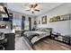 Comfortable bedroom with ceiling fan, decor shelves, and neutral color scheme at 5515 69Th E Pl, Ellenton, FL 34222