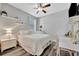 Bright bedroom featuring white furniture, light walls, and wood-style flooring at 5515 69Th E Pl, Ellenton, FL 34222