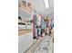 Organized walk-in closet with built-in shelving, hanging rods, and ample storage space at 5515 69Th E Pl, Ellenton, FL 34222