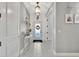 Bright foyer features tile flooring, wainscoting, and a stylish entry table with a decorative mirror at 5515 69Th E Pl, Ellenton, FL 34222
