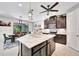 A modern kitchen features a marble island, stainless steel appliances, and dark wood cabinets at 5515 69Th E Pl, Ellenton, FL 34222