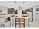 Kitchen showcasing a center island with granite countertops, seating and dark cabinets at 5515 69Th E Pl, Ellenton, FL 34222