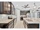 Spacious kitchen features stainless appliances, white tile floors, and dark cabinets at 5515 69Th E Pl, Ellenton, FL 34222